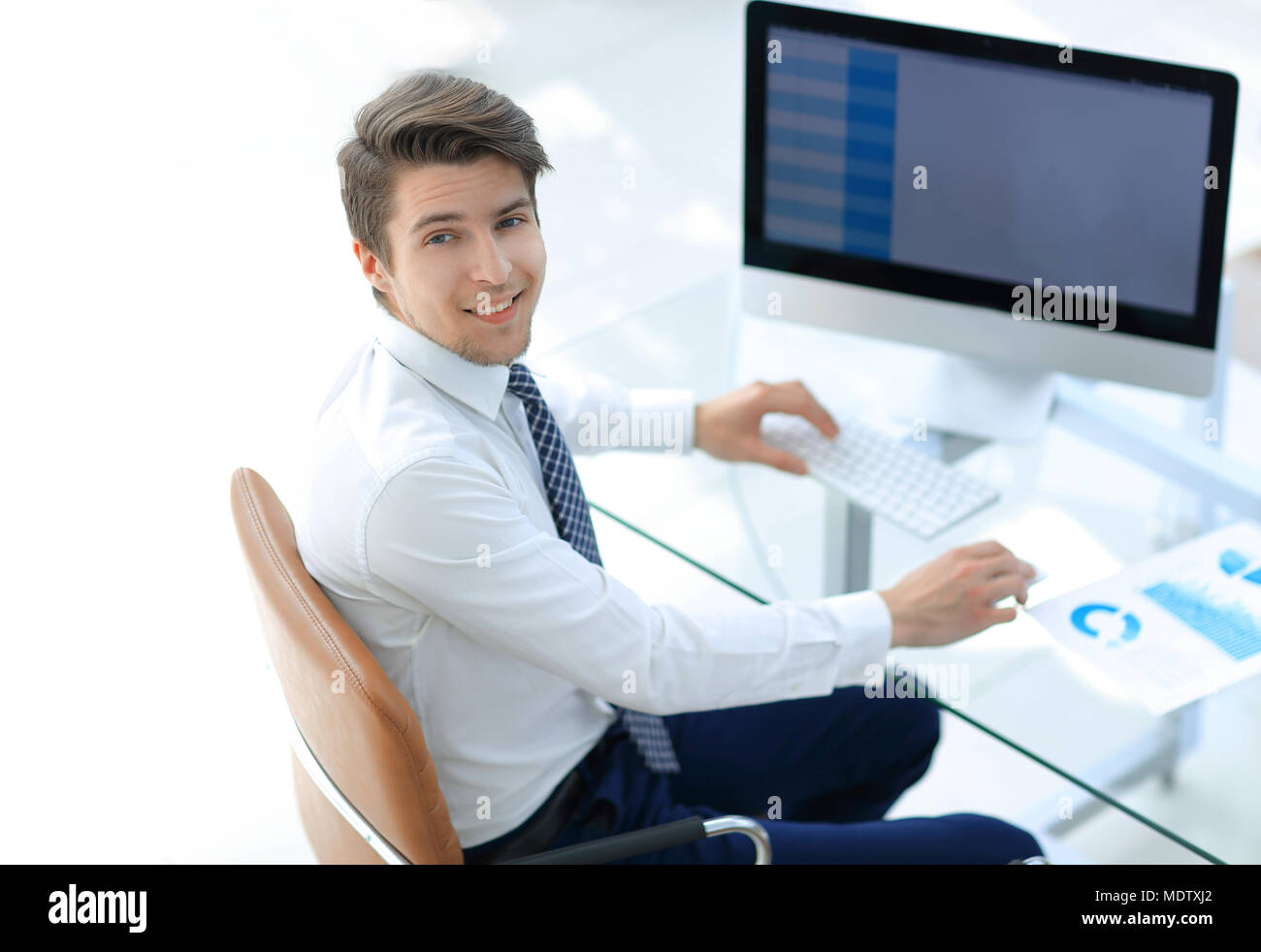 employee sitting in front of a computer screen Stock Photo - Alamy