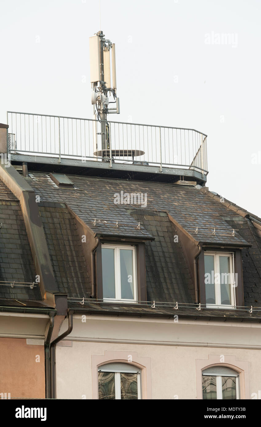 Zurich, Switzerland - 7 March 2014: Mobile phone antenna on top of an apartment house in a residential area of Zurich, Switzerland. Scientists warn ab Stock Photo