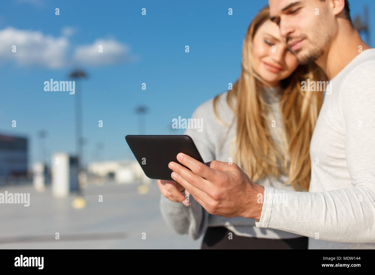 Young couple using digital tablet outdoor, depth of field Stock Photo
