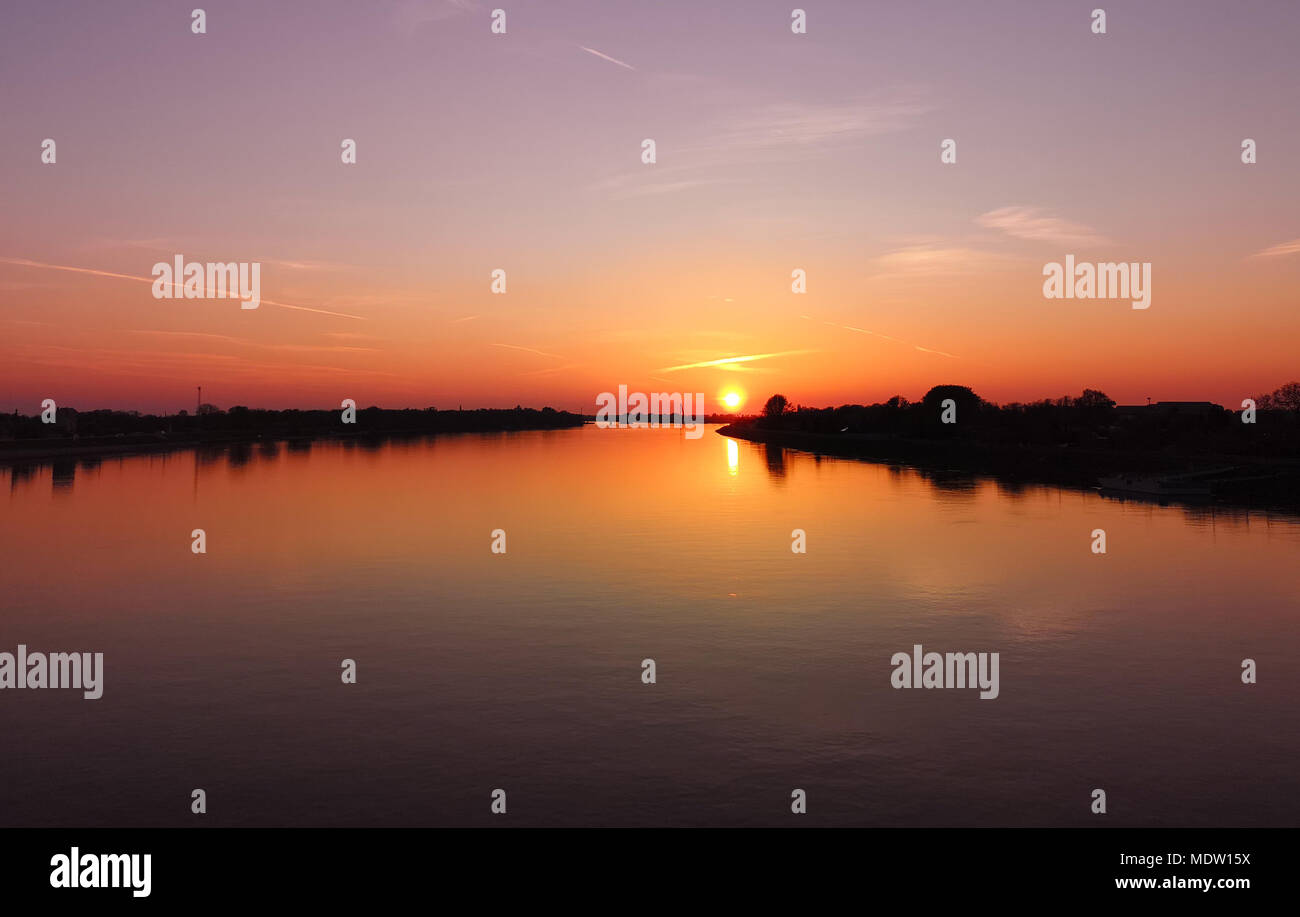 Colorful orange sunset on river Danube, Komarom, Hungary Stock Photo