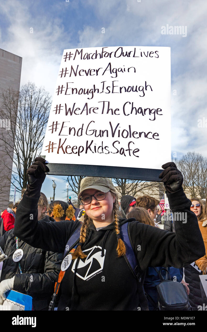 Young female student holding protest sign/banner. March For Our Lives rally against gun violence on March 24, 2018 in Washington, DC. Stock Photo