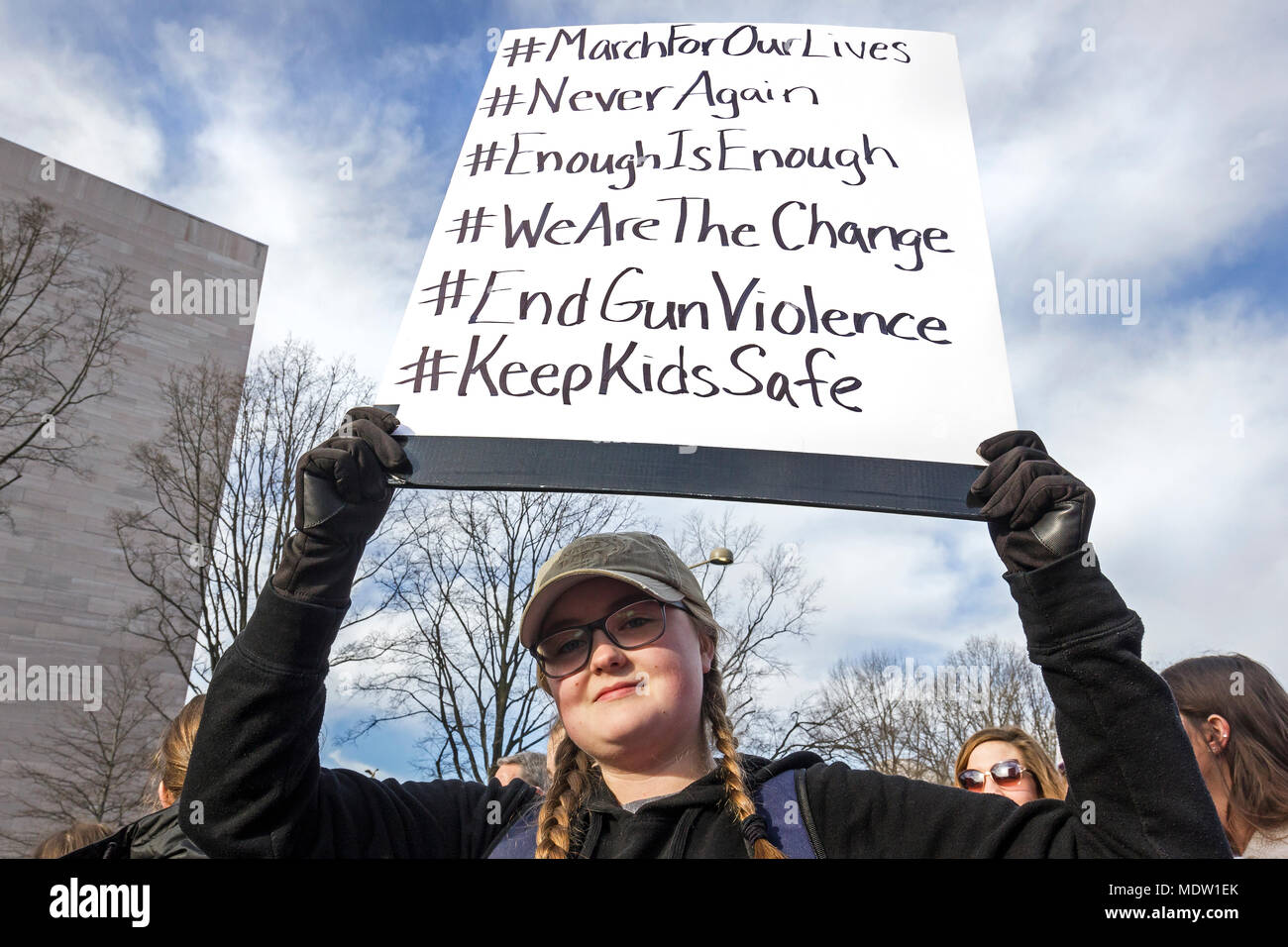 Young female student holding protest sign/banner. March For Our Lives rally against gun violence on March 24, 2018 in Washington, DC. Stock Photo