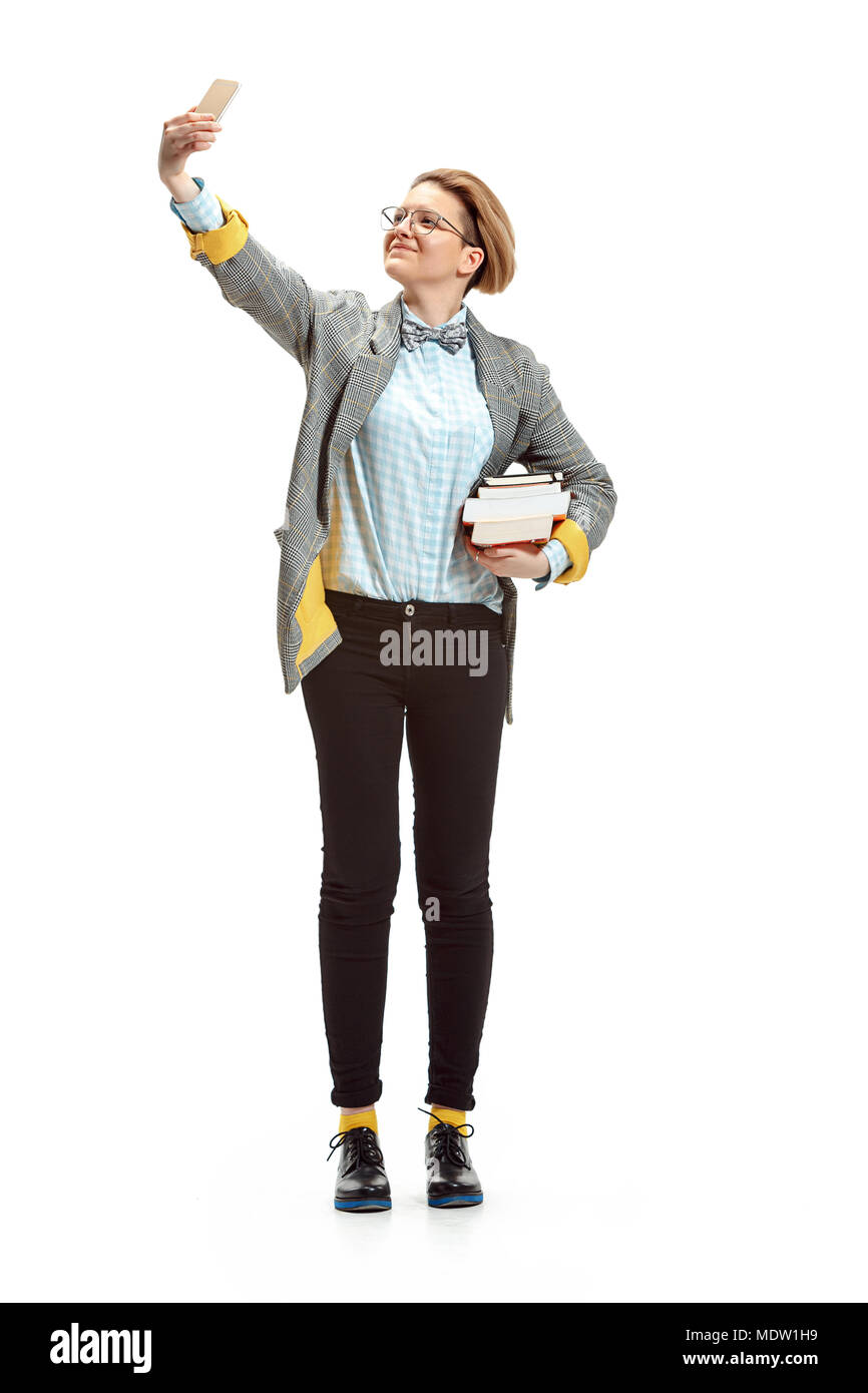 Full length portrait of a happy smiling female student holding books ...