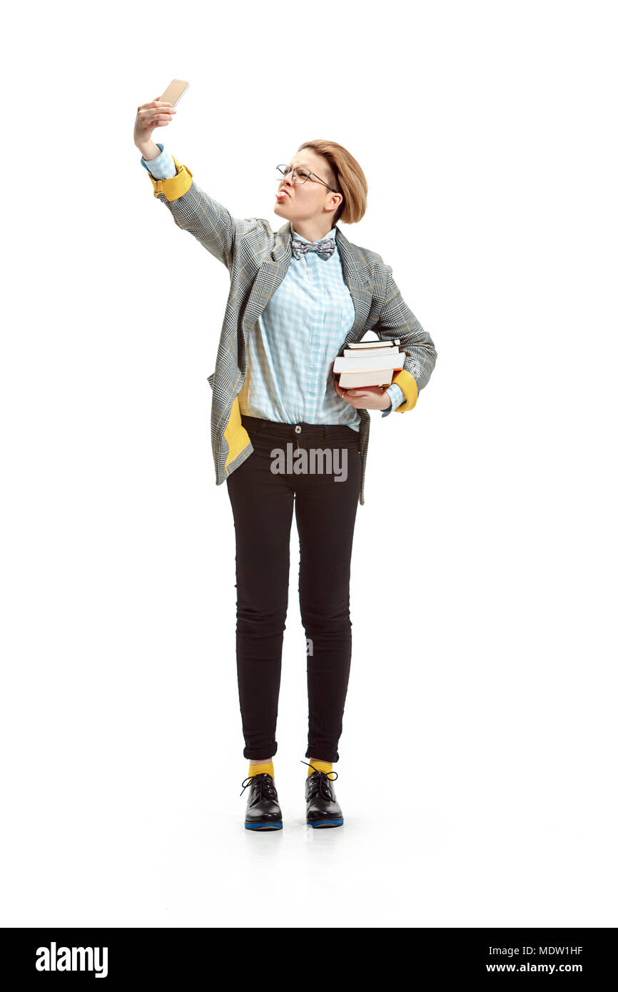 Full length portrait of a happy smiling female student holding books ...