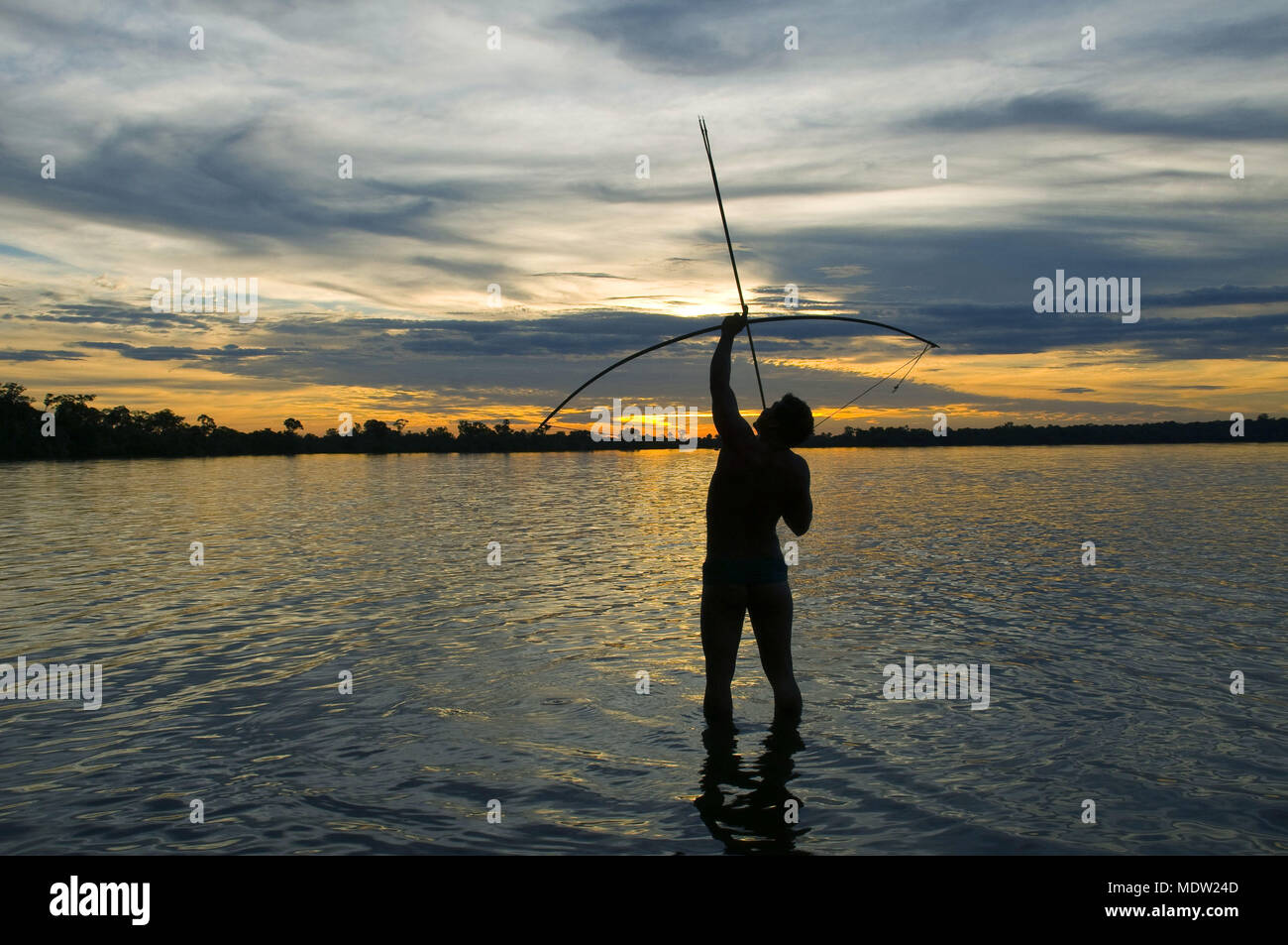 Kalapalo Indian with bow and arrow in Ipa Lake Village Aiha - Indigena Parque do Xingu - MT Stock Photo