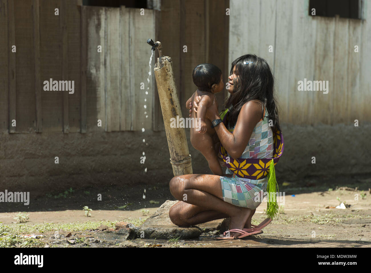 India Kayapo village Moikarako bathing the child on tap Stock Photo
