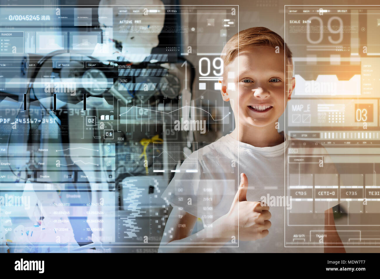 Happy little boy putting his thumb up and smiling Stock Photo - Alamy