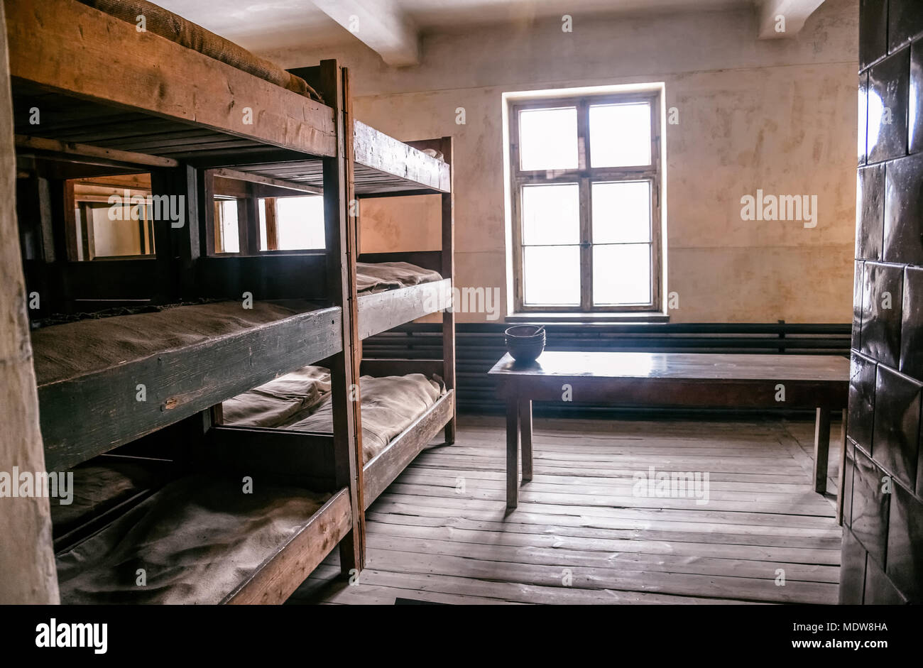 Oswiecim / Poland - 02.15.2018: Prisoner's room with bunks, beds inside the main building of Auschwitz Museum. Stock Photo