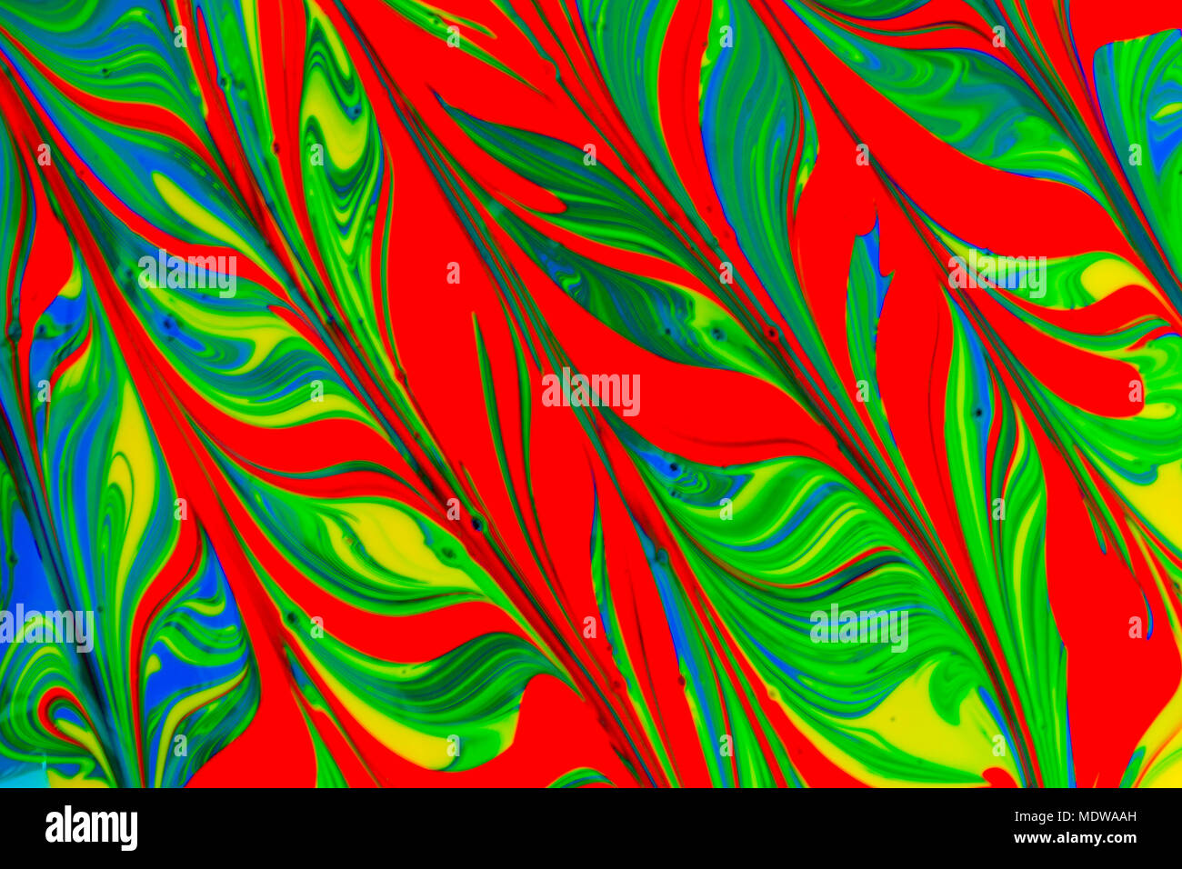 abstract background design in red blue green and yellow paint swirls ...