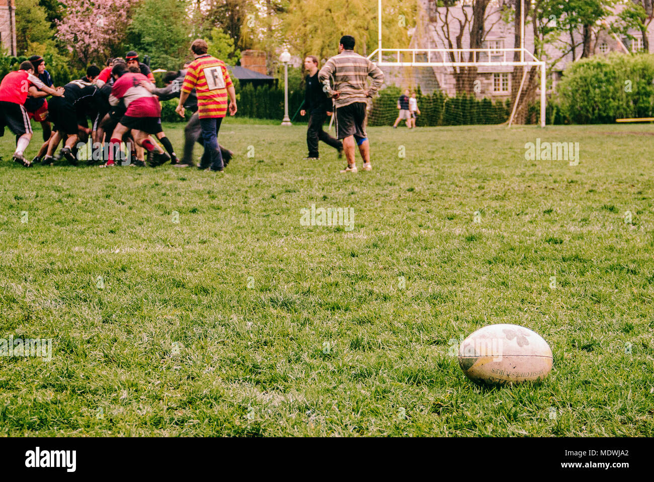 Playing Rugby Outside Kids playing with rugby ball in park hi-res stock photography and ...