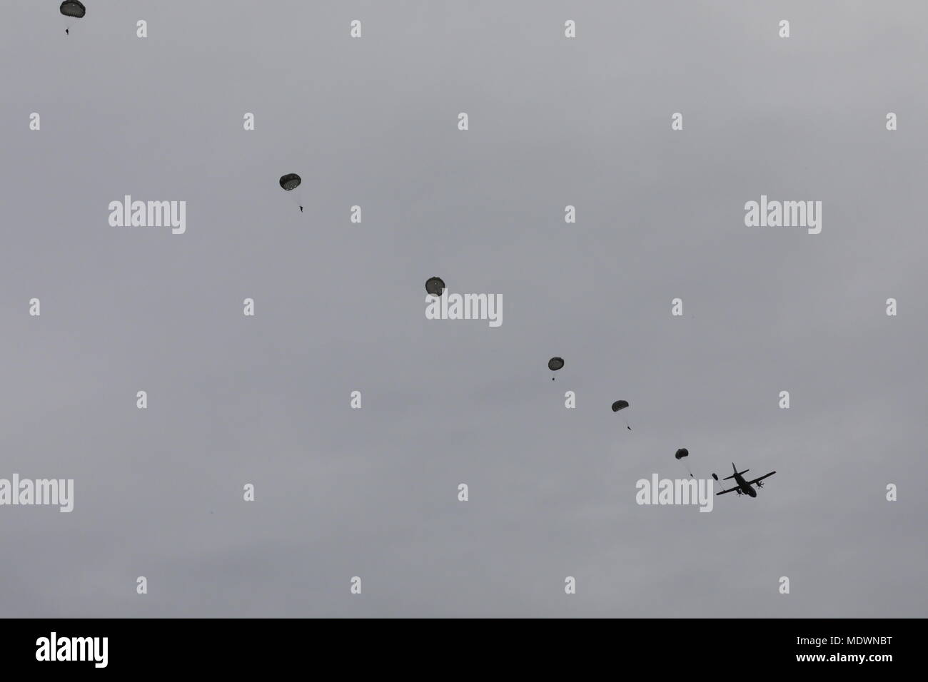 U.S. Army paratroopers fill the sky after jumping from the C-27J Spartan onto Luzon drop zone for the 20th Annual Randy Oler Memorial Operation Toy Drop, hosted by U.S. Army Civil Affairs & Psychological Operations Command (Airborne), Dec. 7, 2017 at Camp MacKall, North Carolina. Operation Toy Drop is the world’s largest combined airborne operation with nine partner nation paratroopers participating and allows Soldiers the opportunity to train on their military occupational specialty, maintain their airborne readiness, and give back to the local community. (U.S. Army Photo by Spc. Madelyn Hanc Stock Photo