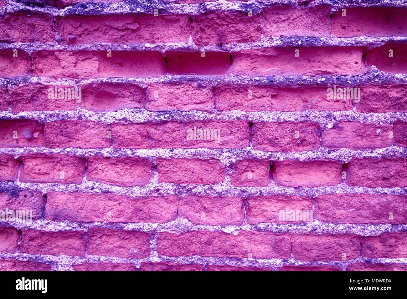 Old ultra purple brick wall, stone background or rock surface - good for web site or mobile devices. Stock Photo