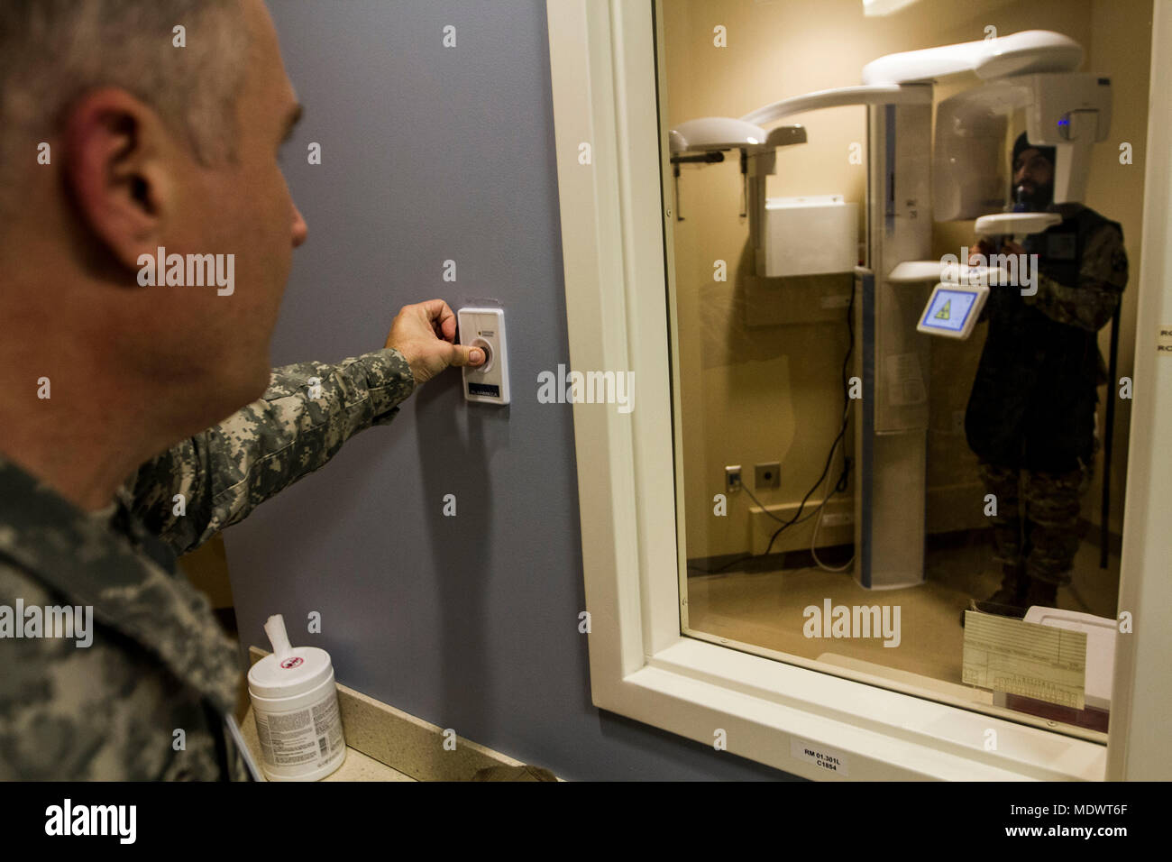 Sgt. Owen Roberts, 7250th Medical Support units, performs an xray on