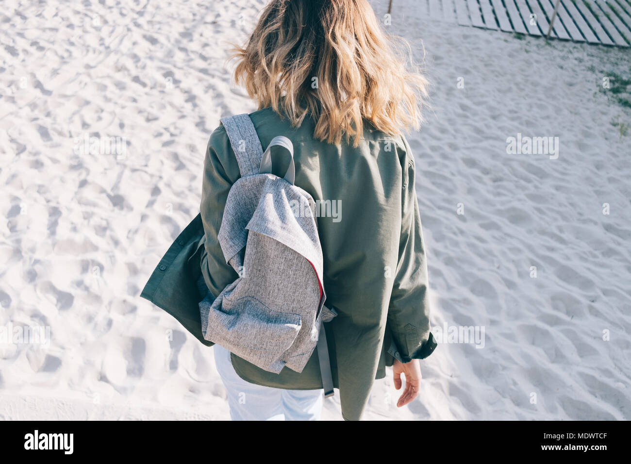 Back View Hipster Girl With Shining Fluttering Blonde Hair Goes To