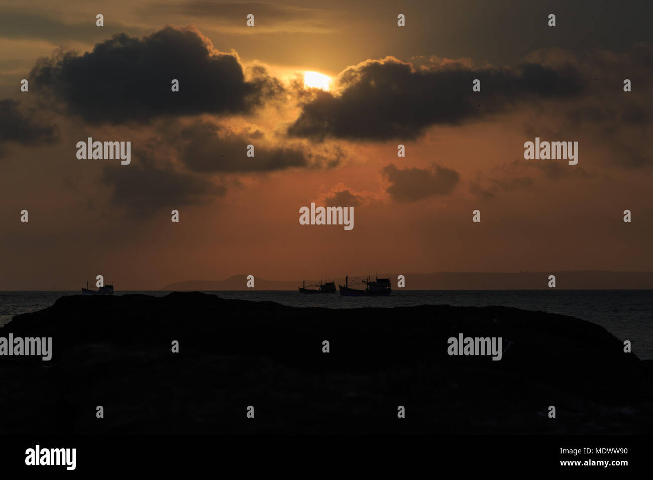 fishing boat to the sea at sunset Stock Photo - Alamy