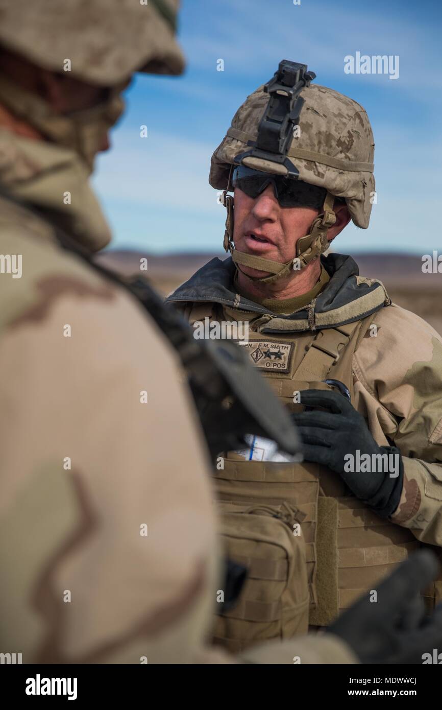 U.S. Marine Corps Maj. Gen. Eric M. Smith, left, the commanding general for 1st Marine Division, talks with a Marine during a battle field circulation (BFC) at Marine Corps Air Ground Combat Center, Twentynine Palms, Calif., Dec. 10, 2017. Smith's BFC consisted of visiting various units participating in exercise Steel Knight 2018. (U.S. Marines Corps photo by Staff Sgt. Gabriela Garcia) Stock Photo