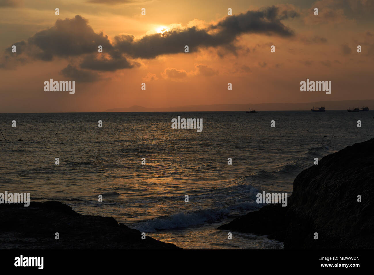fishing boat to the sea at sunset Stock Photo - Alamy