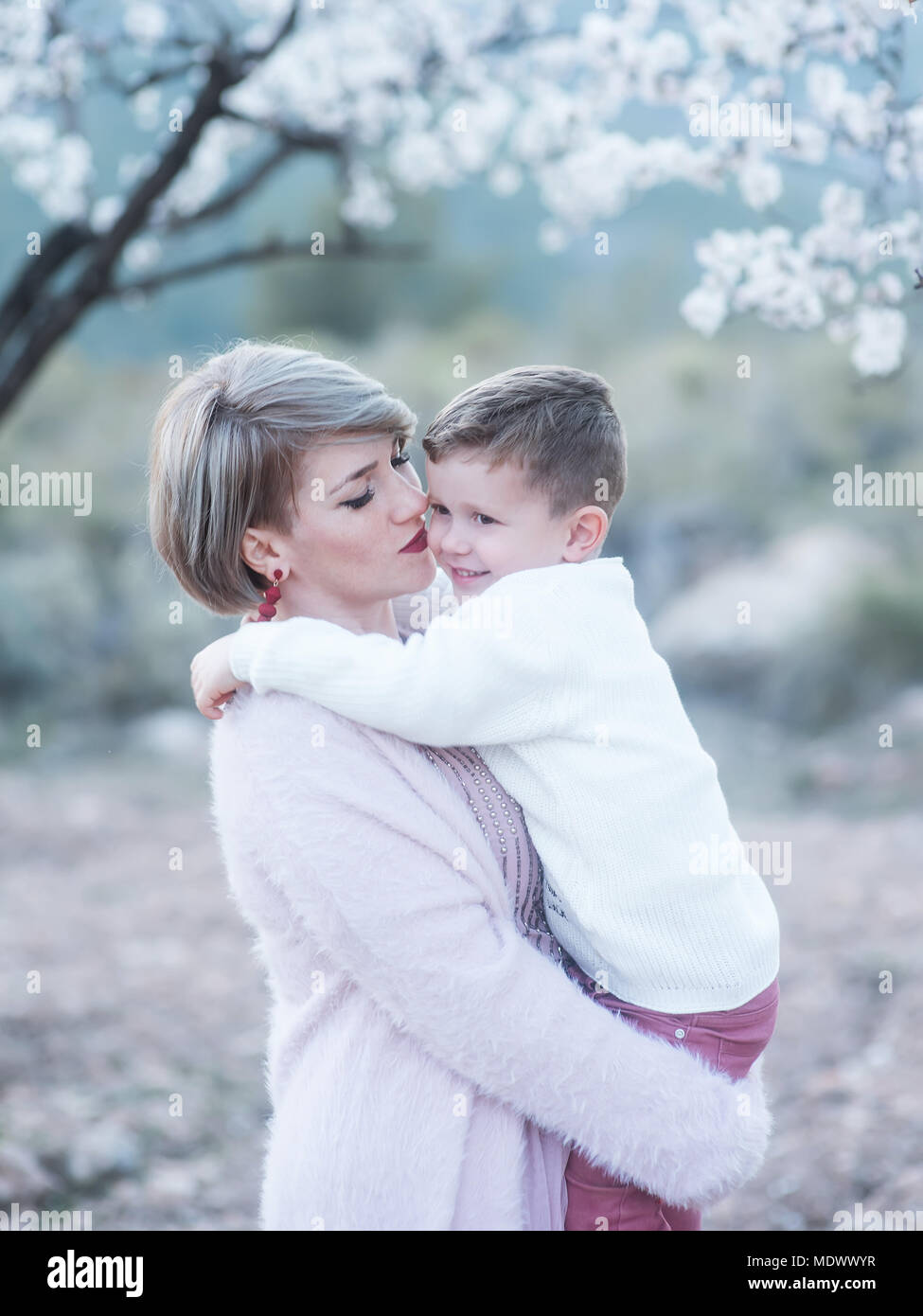 Mom and her son are embraced tenderly. Stock Photo