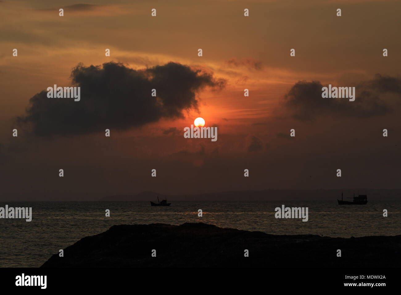fishing boat to the sea at sunset Stock Photo - Alamy