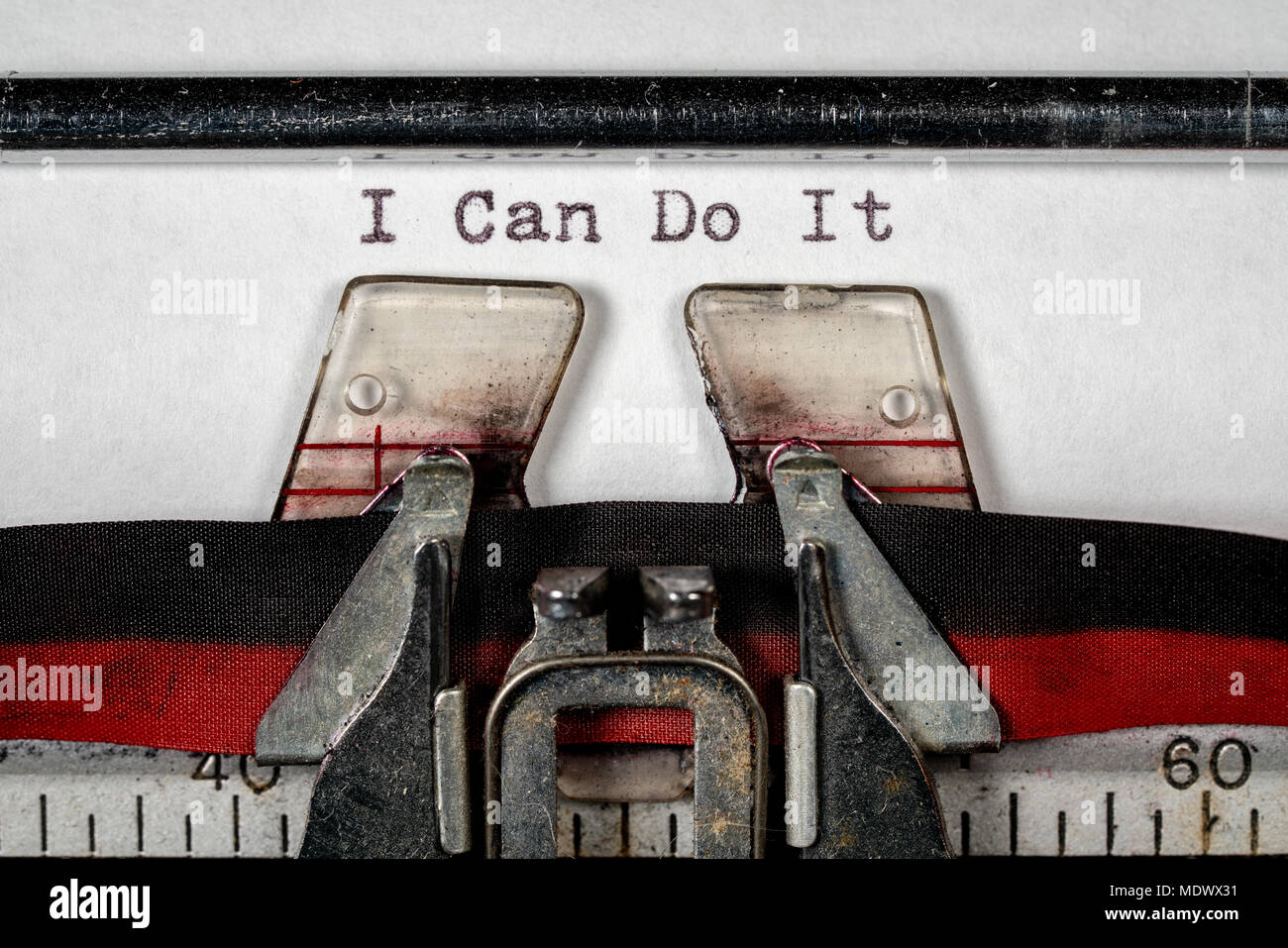 Macro of the ribbon and paper of typewriter with positive confident message Stock Photo