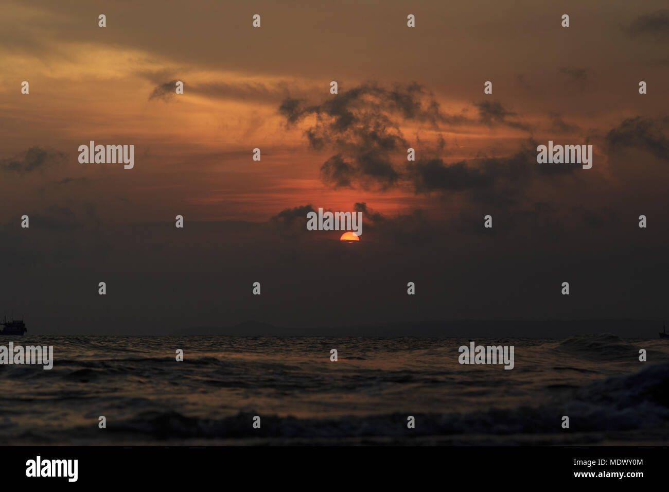 fishing boat to the sea at sunset Stock Photo - Alamy