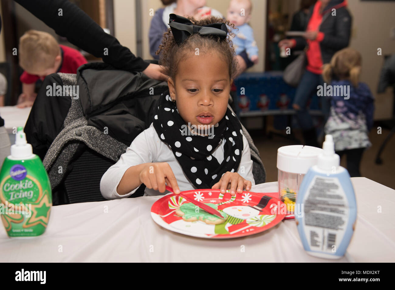A child decorates a cookie at the Airman and Family Readiness Center on
