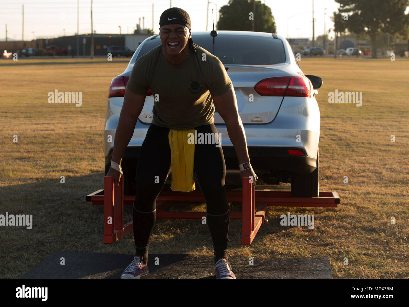 U.S. Marine Corps Sgt. Christopher Deon Fisher Jr., an Aviation Ordnance Technician assigned to Marine Aviation Logistics Squadron 13, stationed at Marine Corps Air Station (MCAS) Yuma, Ariz., deadlifts a vehicle to practice for the Strongman Competition Dec. 15, 2017 on the station parade deck. The practice is to prepare for the Bull of the Desert Strongman Competition slated Feb. 17, 2018 in Yuma, Ariz. (U.S. Marine Corps photo by Lance Cpl. Sabrina Candiaflores) Stock Photo