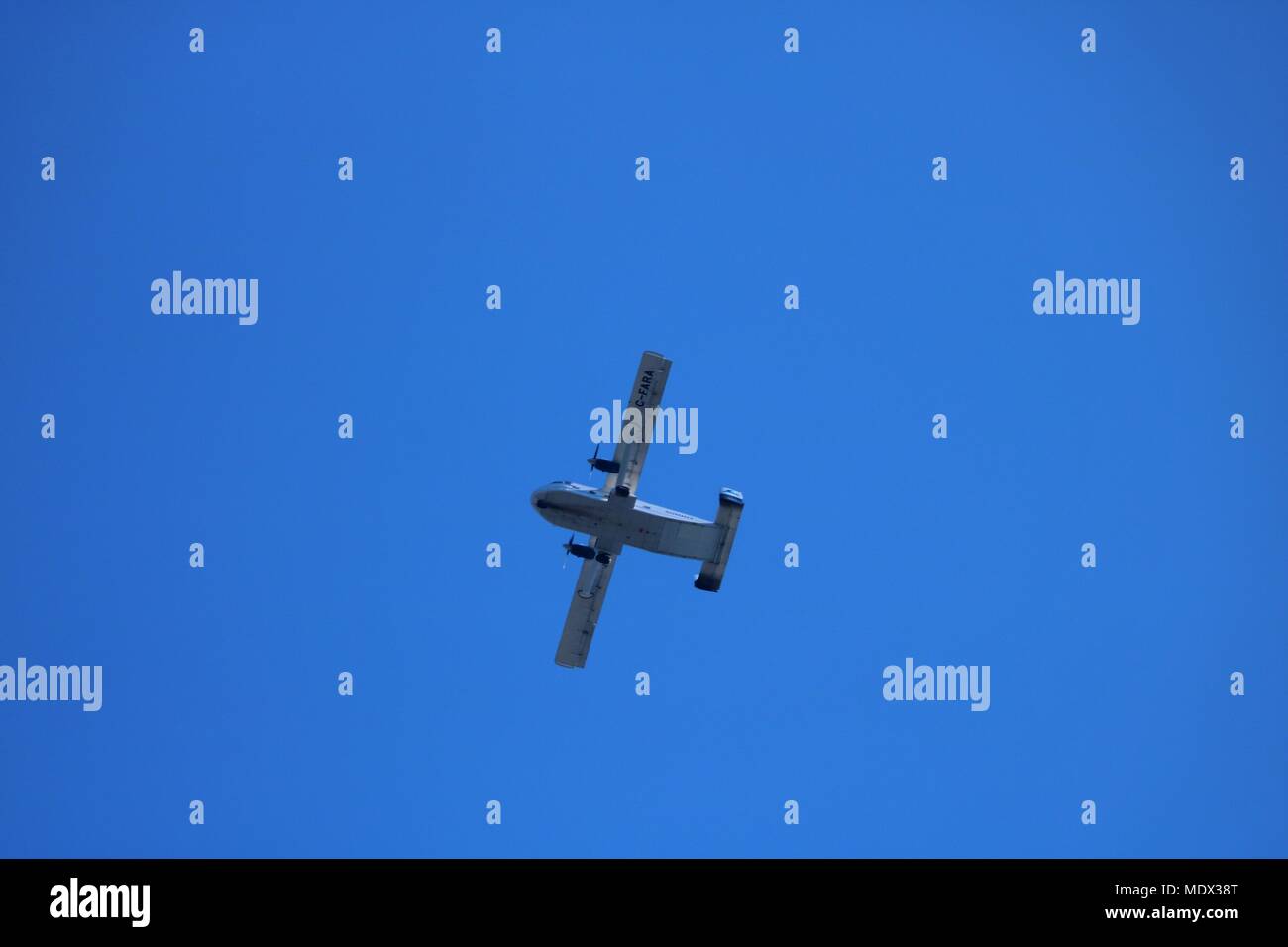 Light aircraft in flight against a blue sky Stock Photo