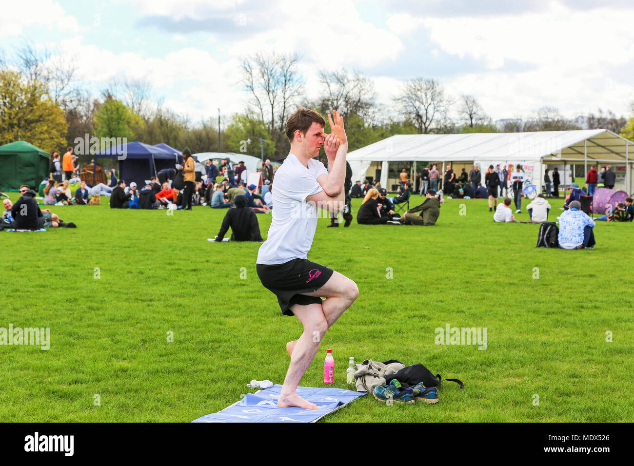 Glasgow, UK. 20th April 2018. Over 1000 people are expected to attend the 11th annual '420 Hempstock' festival in Glasgow Green park as part of the national and international celebration of cannabis and its therapeutic uses when around the world there will be a simultaneous 'light up' at 4.20pm. ALLAN GRAHAM from Glasgow regularly attends Glasgow Green to practice his 'warrior Eagle' yoga posture and was not put off by the festival. Credit: Findlay/Alamy Live News Stock Photo