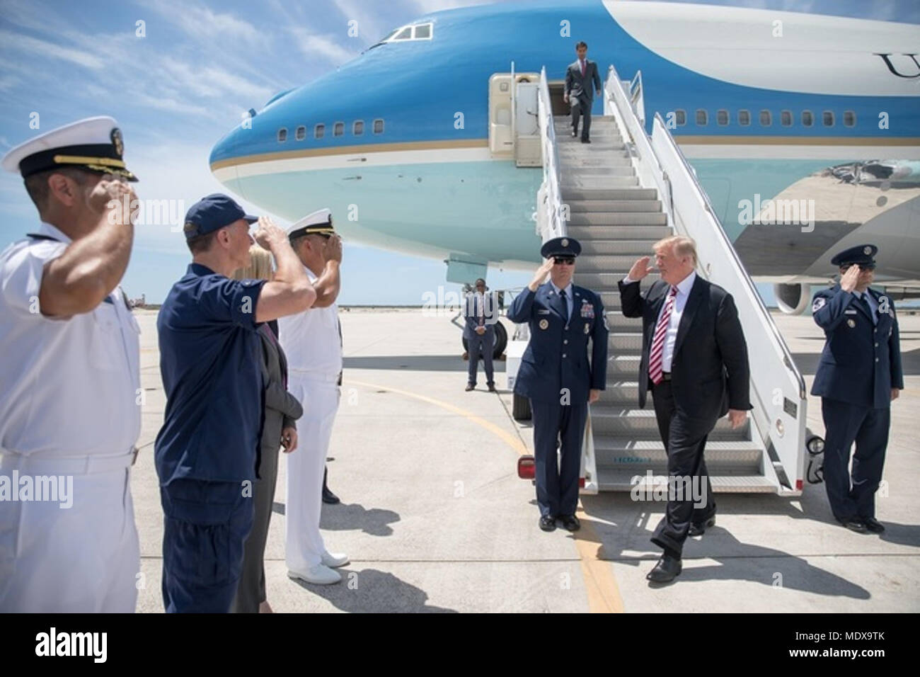 MIAMI, FL - WEEK OF APRIL 16: President Donald J. Trump waves as he disembarks Marine One at Joint Base Andrews, MD, Monday, April 16, 2018, escorted to Air Force One by Col. Casey Eaton, Commander 89th Airlift Wing, at Andrews Air Force Base. President Trump is flying to Miami International Airport to participate in a tax cuts for Florida small businesses roundtable at Bucky Dent Park, Monday, April 16, 2018, in Hialeah, FL   People:  President Donald Trump Stock Photo