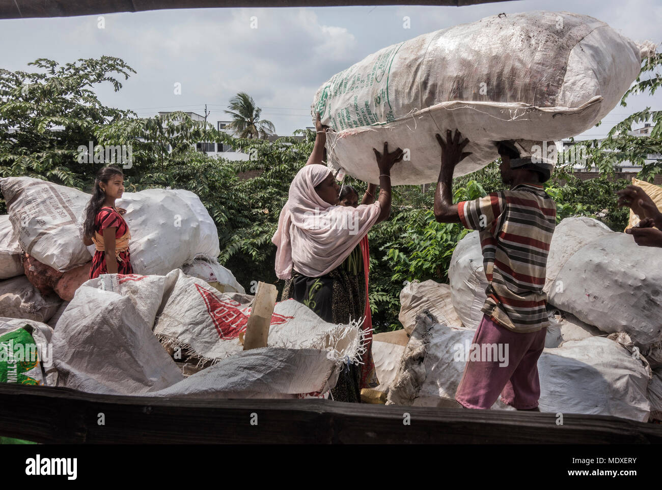 Kolkata, India. 21st Apr, 2018. Labors carry plastic materials at a