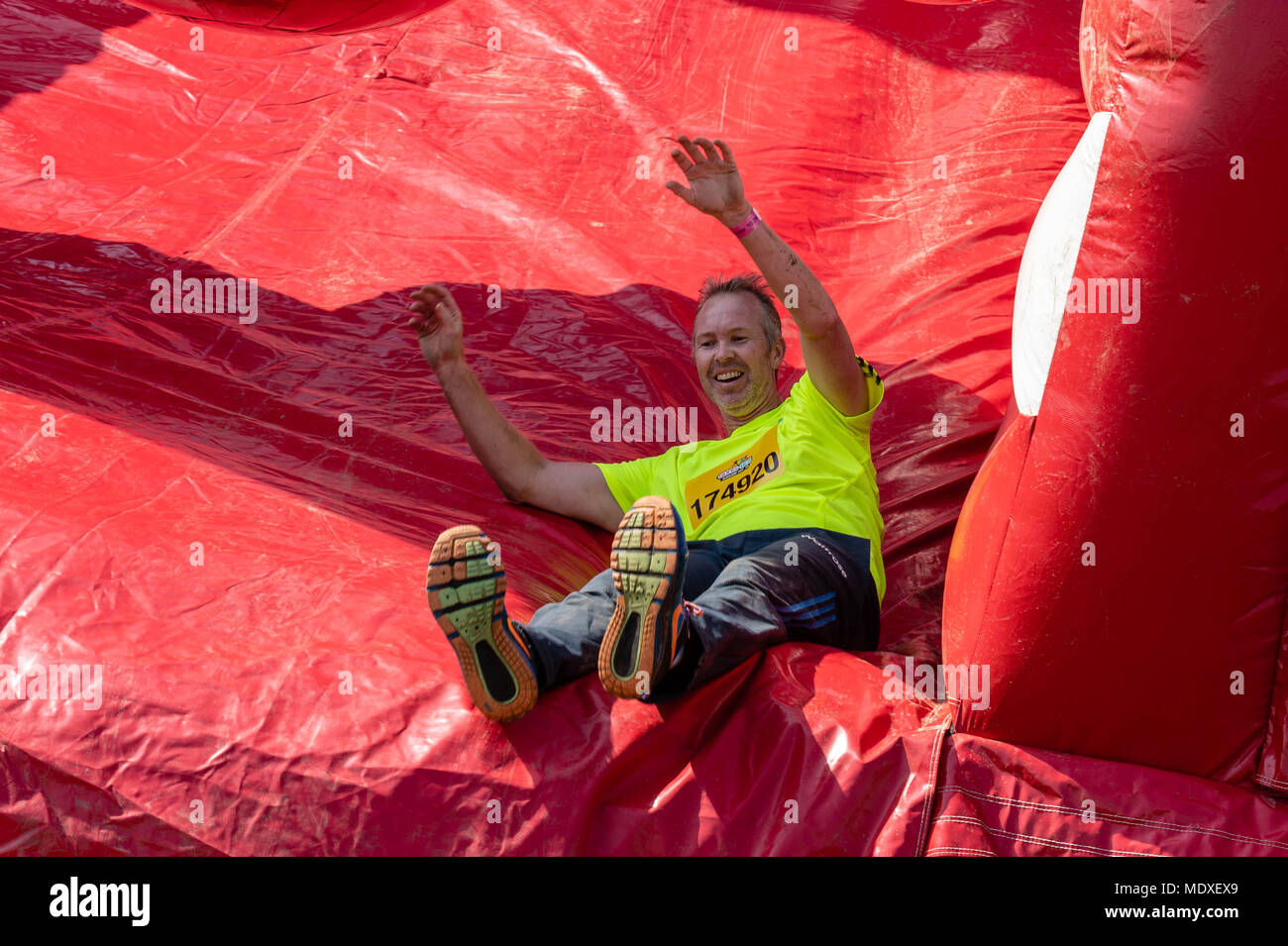 Essex, UK. 21st April, 2018. Spring fun in the sun, the Gung-Ho 5k obstacle Course event with several thousand participants who cover a five kilometre fun run over giant inflatable obstacles with finale is Europe’s biggest ever inflatable slide held its first event of the year at Weald Country Park, Brentwood, Essex, UK. Credit: Ian Davidson/Alamy Live News Stock Photo