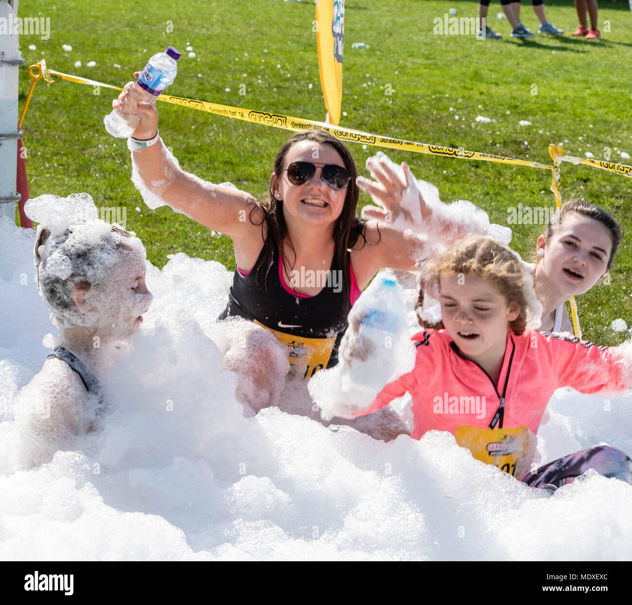 Essex, UK. 21st April, 2018. Spring fun in the sun, the Gung-Ho 5k obstacle Course event with several thousand participants who cover a five kilometre fun run over giant inflatable obstacles with finale is Europe’s biggest ever inflatable slide held its first event of the year at Weald Country Park, Brentwood, Essex, UK. Credit: Ian Davidson/Alamy Live News Stock Photo