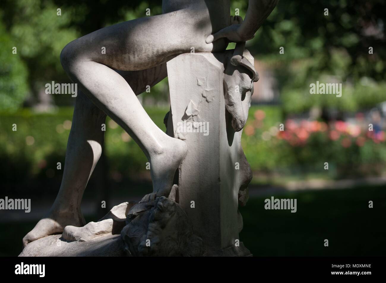 Paris, Parc Monceau, detail of a sculpture, ephebe and pigeons, Stock Photo