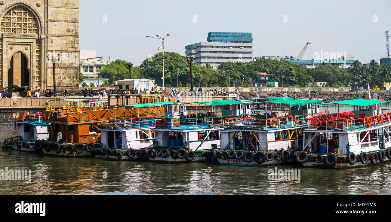 Boats mooring along the coast on the Arabian Sea at the Gateway of India; Mumbai, Maharashtra, India Stock Photo