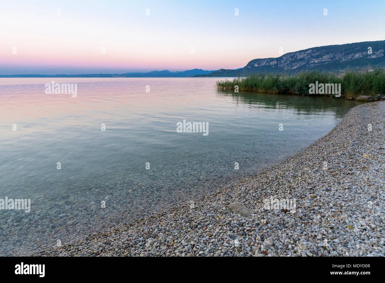 Close-up of shoreline at Lake Garda (Lago di Garda) at dawn in Garda in Veneto, Italy Stock Photo