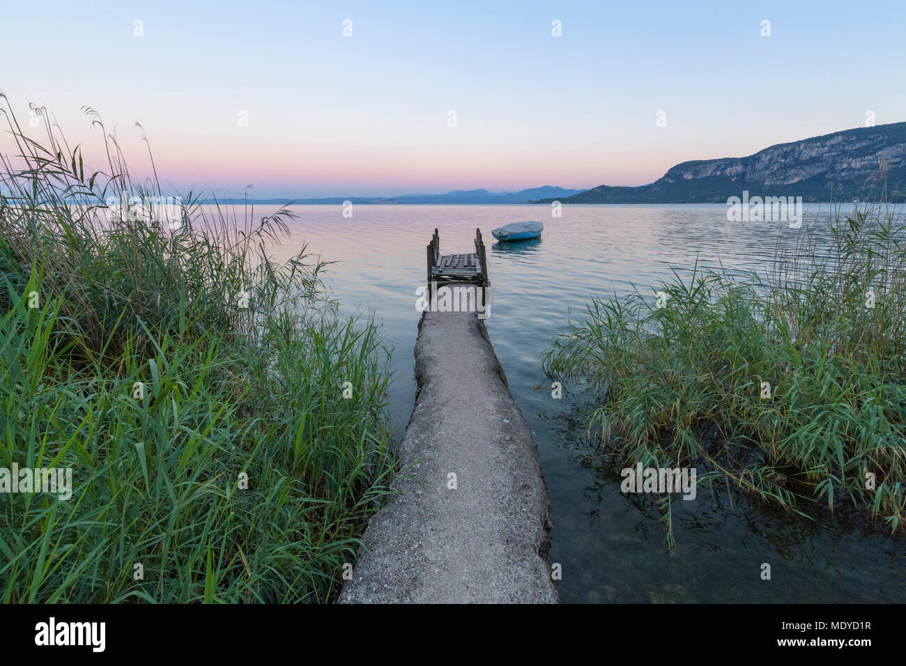 Angler jetty on Lake Garda (Lago di Garda) at dawn in Garda in Veneto, Italy Stock Photo