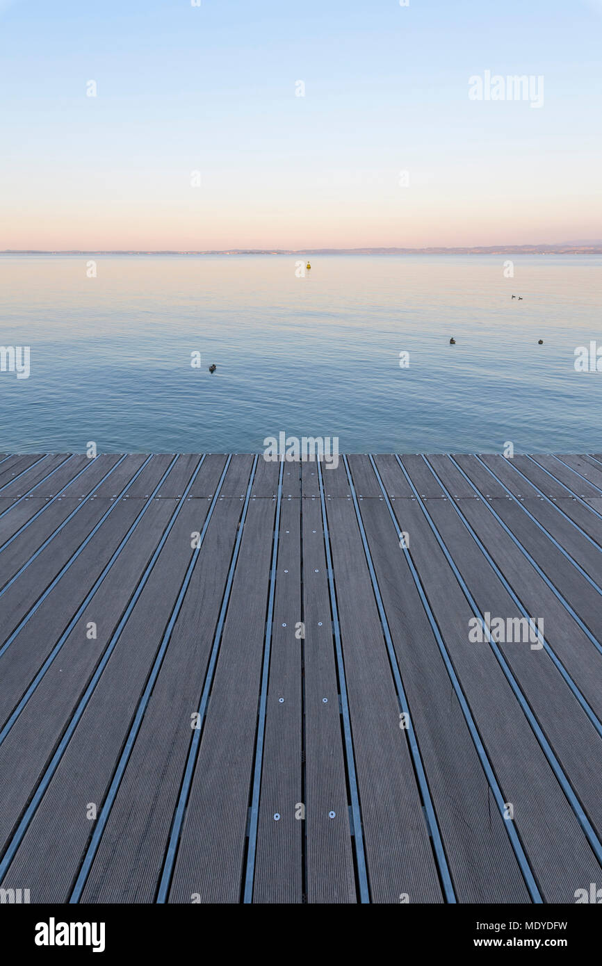 Boardwalk at dawn overlooking Lake Garda (Lago di Garda) in Bardolino in Veneto, Italy Stock Photo