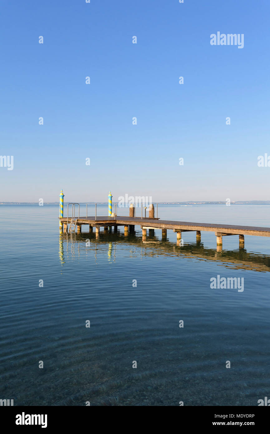 Wooden jetty on Lake Garda (Lago di Garda) in the morning at Bardolino in Veneto, Italy Stock Photo