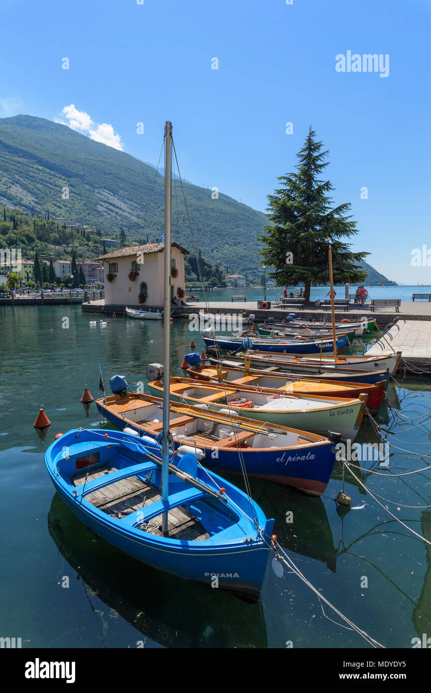 Row of fishing boats docked in the port on Torbole on Lake Garda (Lago ...