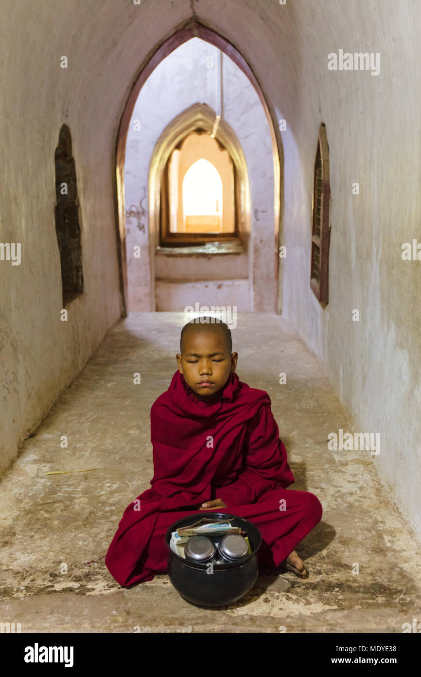 Portrait of a young monk meditating inside the 'Ananda Temple'. Bagan, Myanmar (Burma). Stock Photo