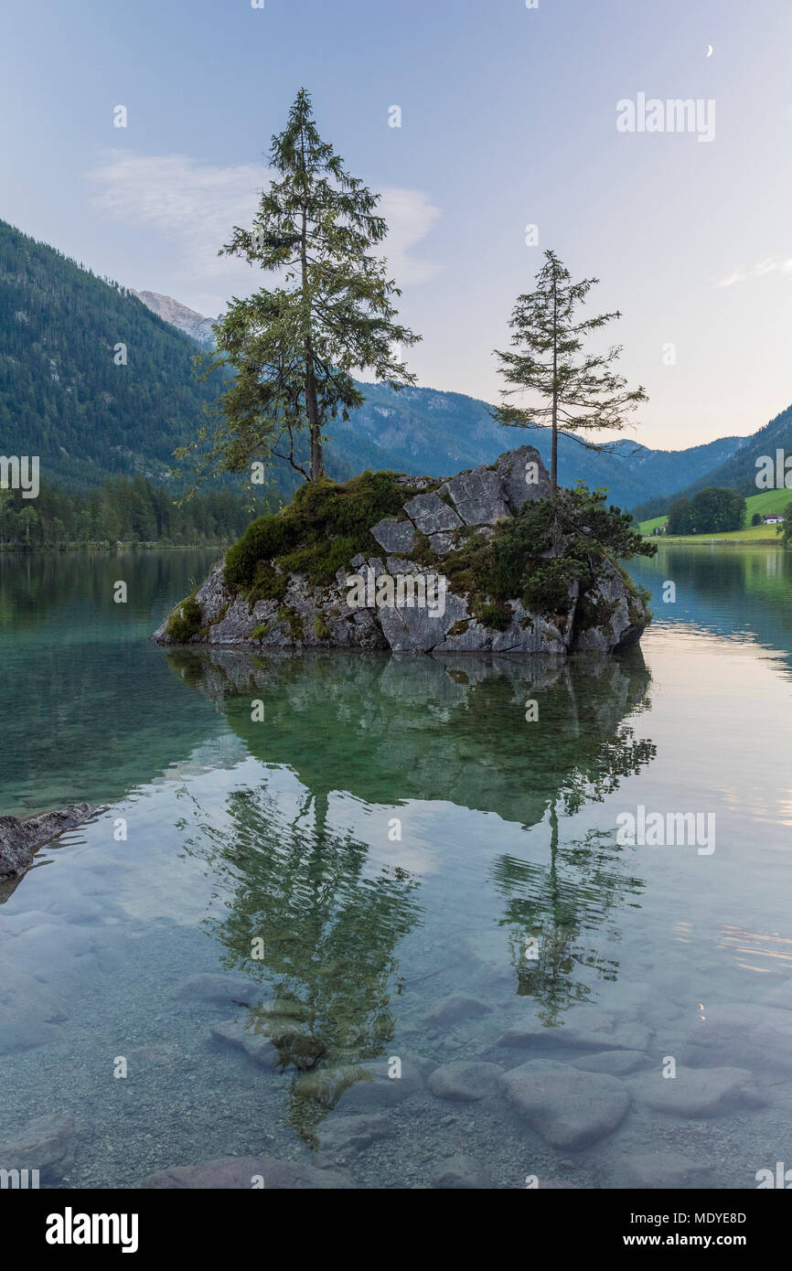 Rock island with trees on Lake Hintersee and mountains at dawn at Ramsau, Berchtesgaden National Park in Upper Bavaria, Germany Stock Photo
