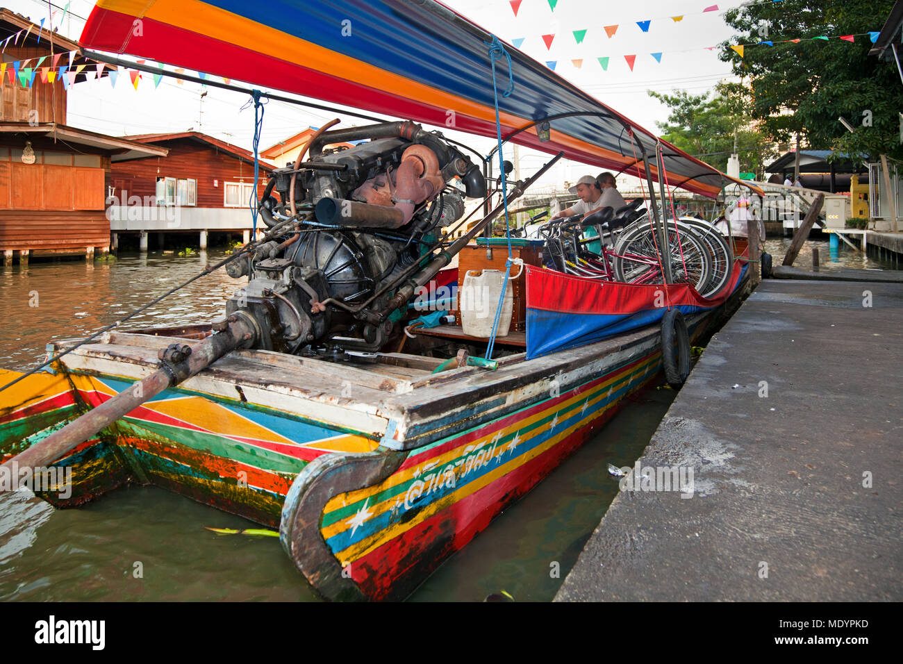 Longtail boat carrying tour bicycles on Chao Phraya river, Bangkok, Thailand Stock Photo