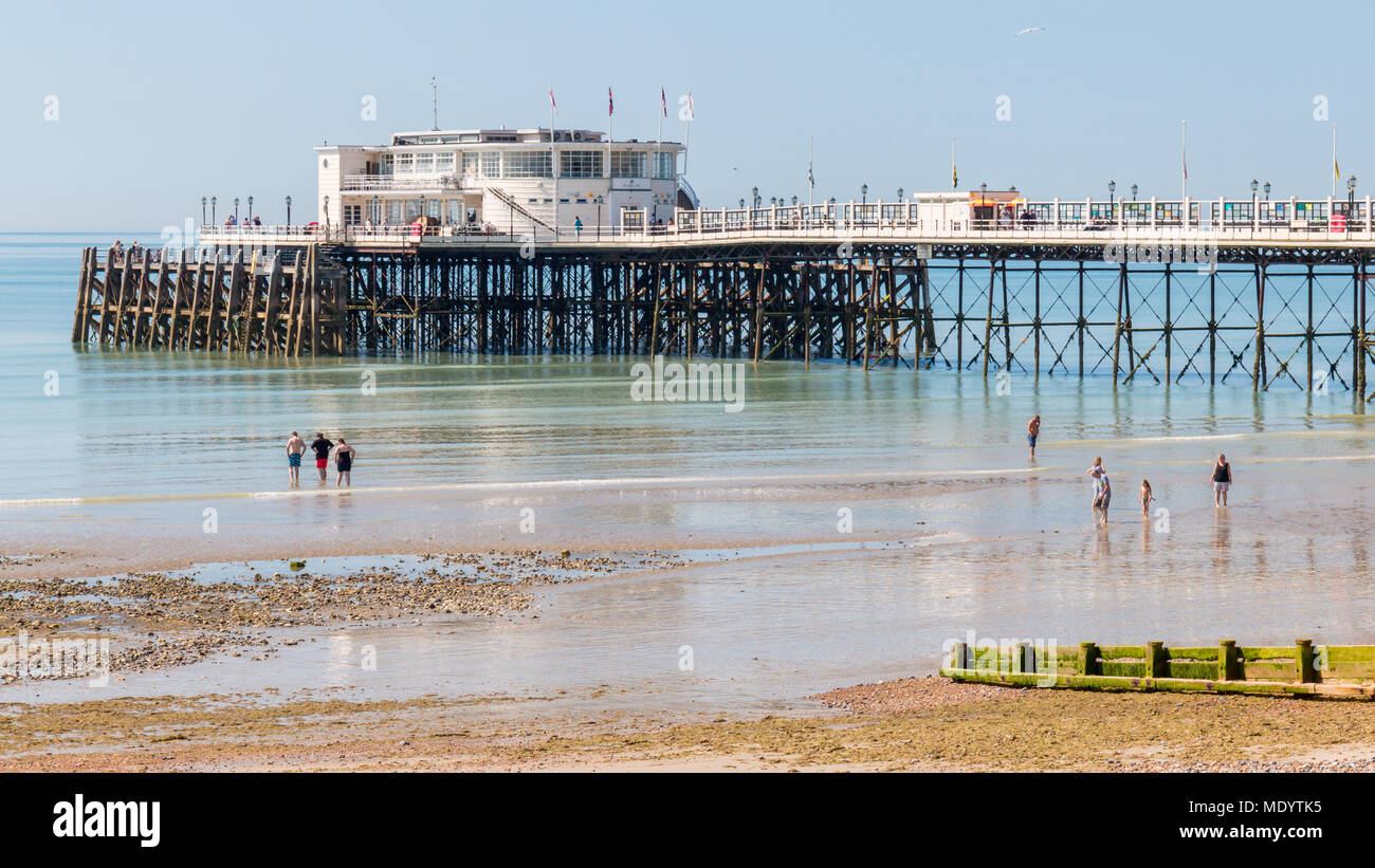 Worthing, Sussex, UK; 18th June 2017; Holidaymakers Paddling at Waters Edge in Sunny Weather With Pier Behind Stock Photo