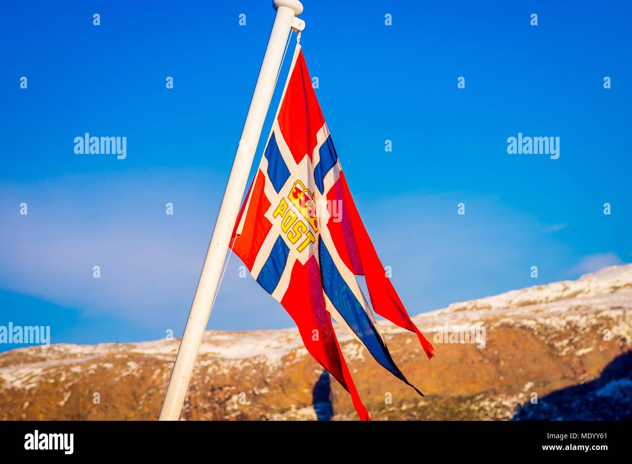 Outdoor view of Norwegian flag waving with a beautiful blue sky ...