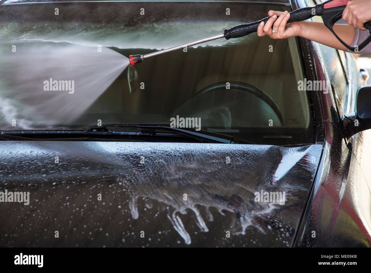 washing machine soapy jet spray aimed at the windshield, closeup photo Stock Photo Alamy