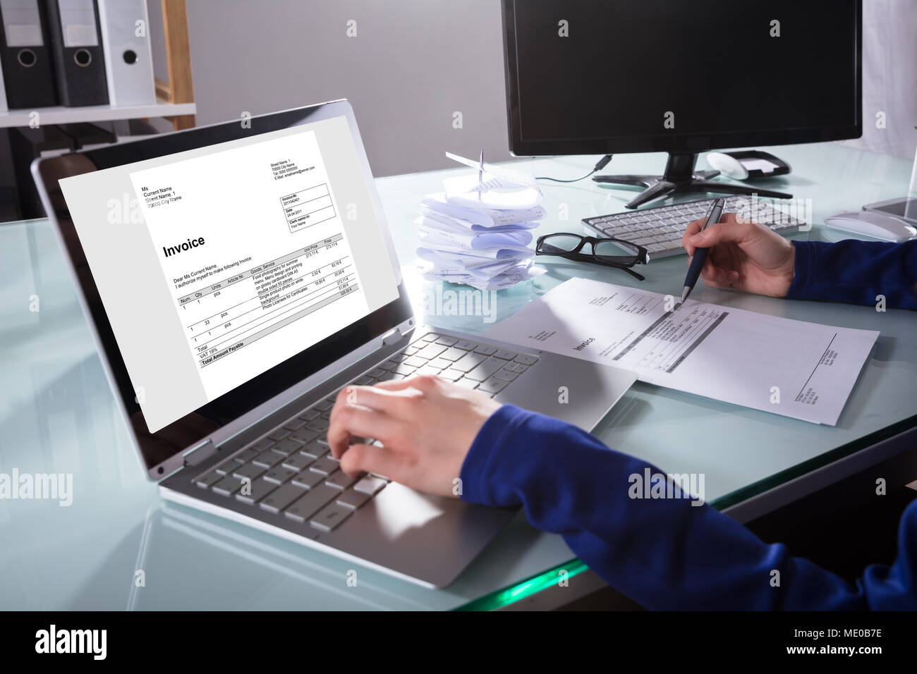 Close-up Of A Businessperson's Hand Checking Invoice On Laptop In ...