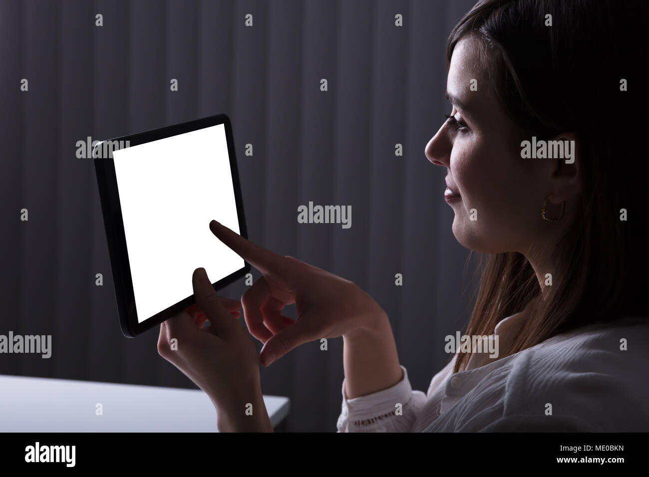 Woman Using Digital Tablet With Blank White Screen Stock Photo