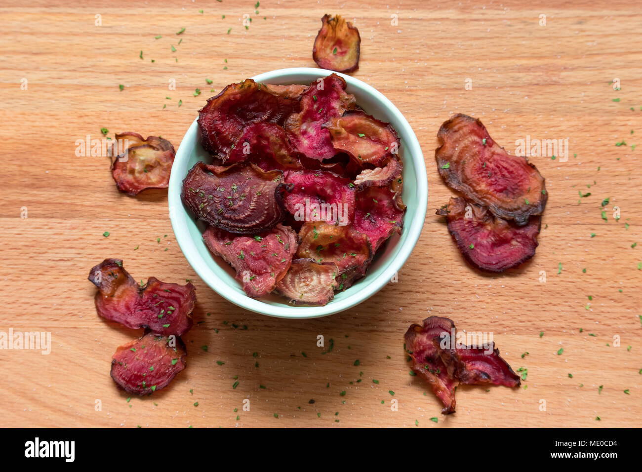 Roasted vegetable chips. These oven-baked candy beetroot crisps are a great healthy snack. Stock Photo