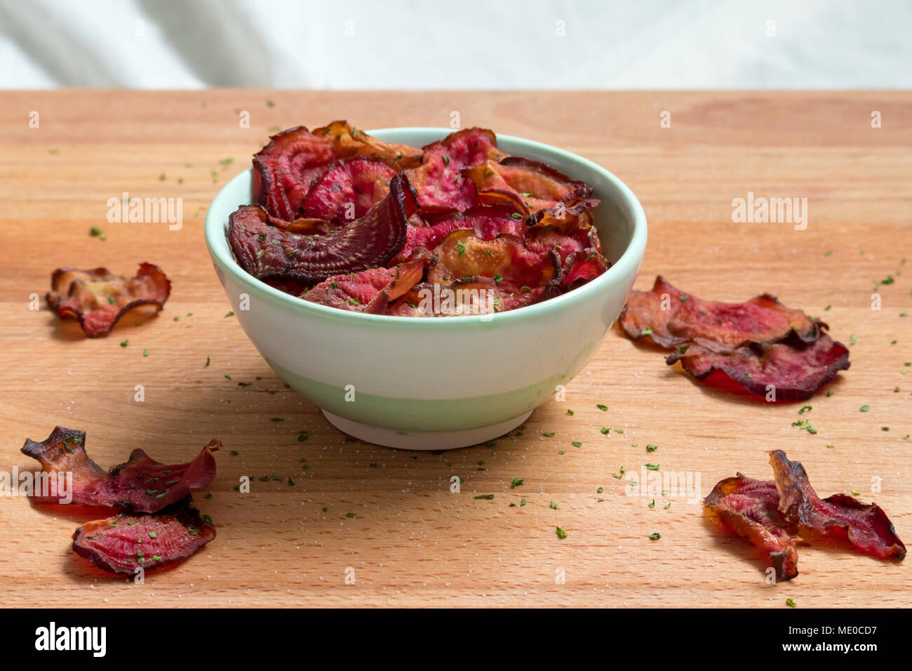 Roasted vegetable chips. These oven-baked candy beetroot crisps are a great healthy snack. Stock Photo